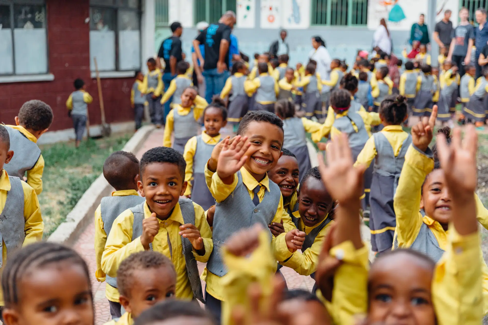 Ethiopian students cheering in a school courtyard